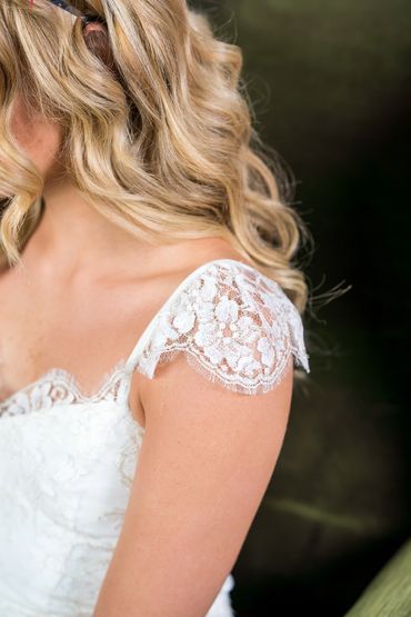 Floral lace Bridal jumpsuit with delicate sleeves and scalloped neckline.