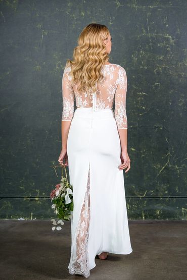 modern wedding outfit with see through lace back and sleeves and floor length fitted skirt.