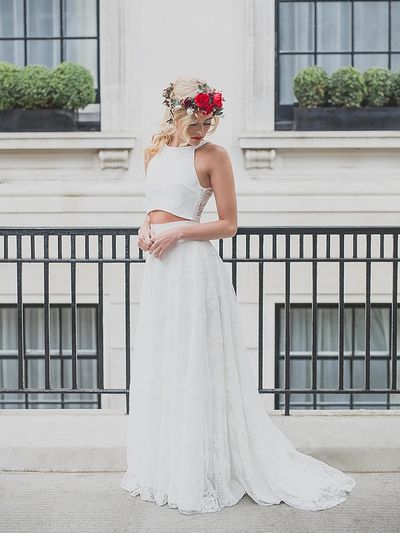 modern bridal two piece. high waisted floor length lace skirt with short train and packets.
