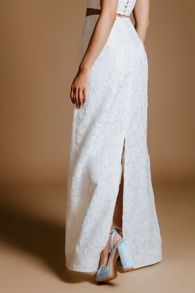 A bridal maxi pencil skirt with a back slit made from floral embossed sheer organza.