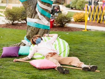 An actor pretends to be asleep on top of a bean bag