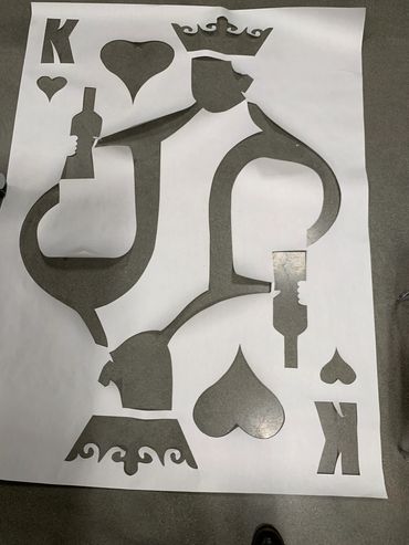 A large poster of a King of Hearts card with the silhouette shape cut out of it.