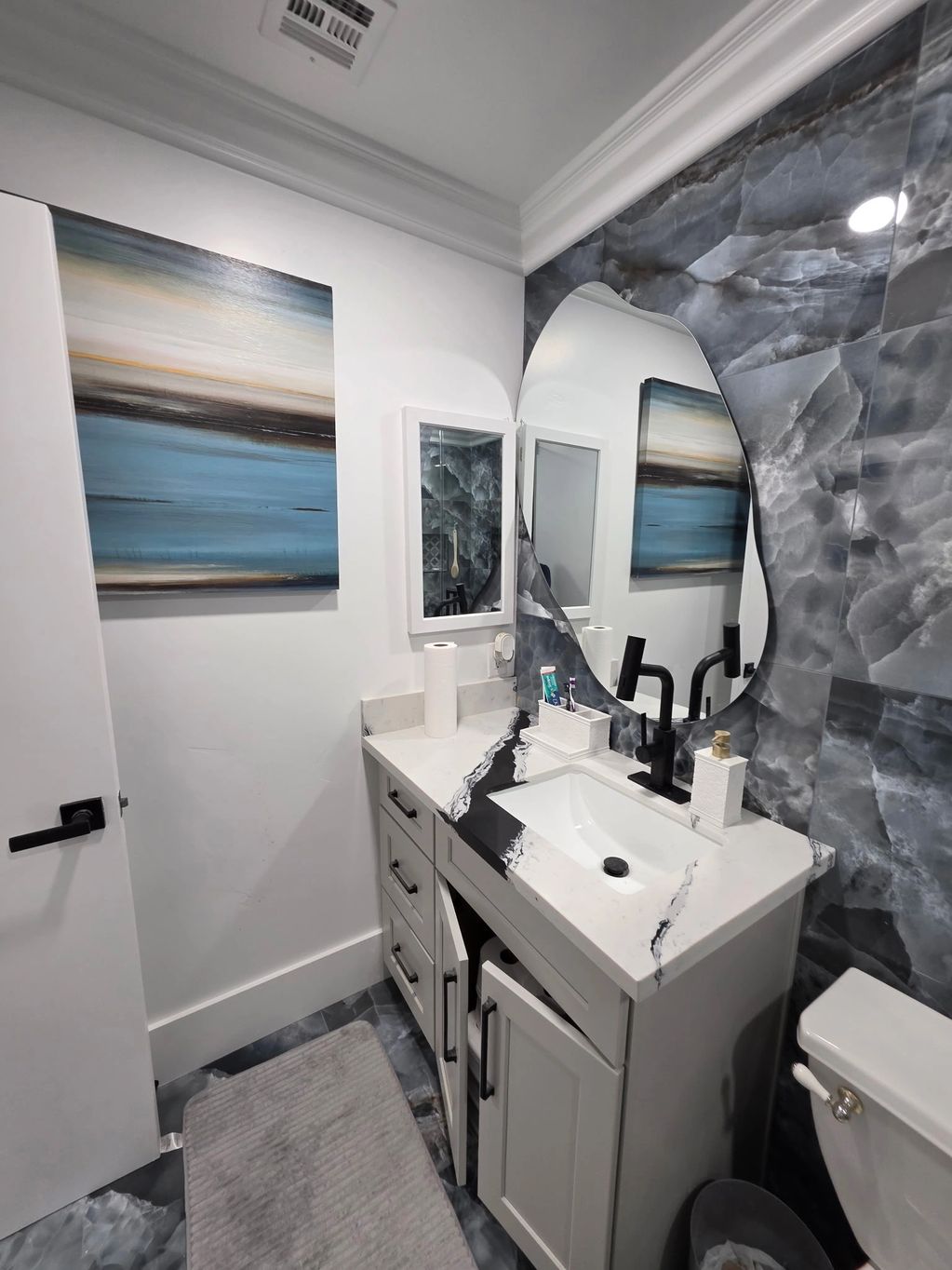 Modern bathroom with artistic design and sleek fixtures.
