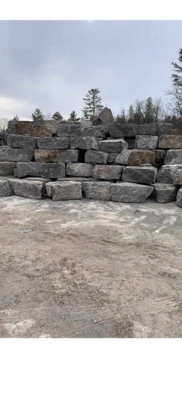 Armour stone pile, black armour, beige armour, natural stone, garden beds, decorative stone, armour