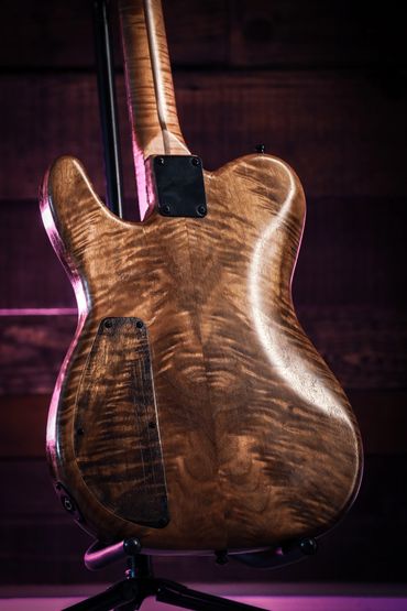 Back view of a beautifully crafted wooden electric guitar with a glossy finish.