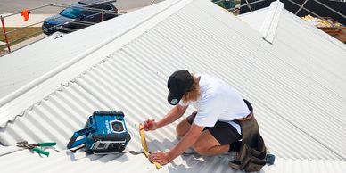 Team roofing maintenance on Sunshine Coast roof.