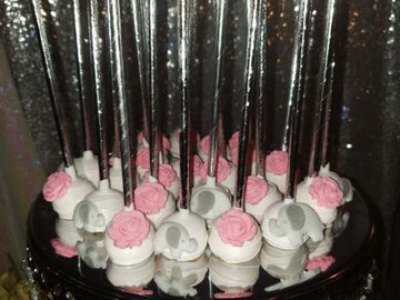 Baby shower cake pops decorated with pink roses and baby elephants with silver cake pop sticks!