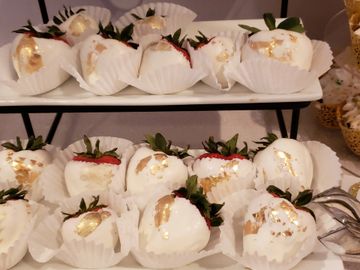 White chocolate covered strawberries with gold leafing.