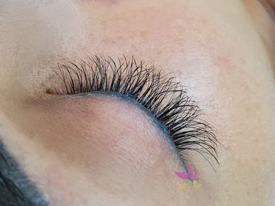 Volume eyelashes shown  on a models closed eye