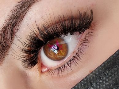 Full eye lash extensions shown on a model with semi-permanent eyebrows
