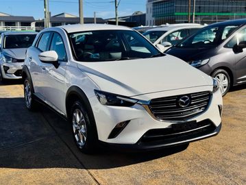 White Mazda CX-3 SUV parked outdoors.