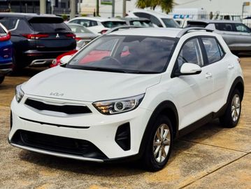 White Kia compact SUV parked outdoors.