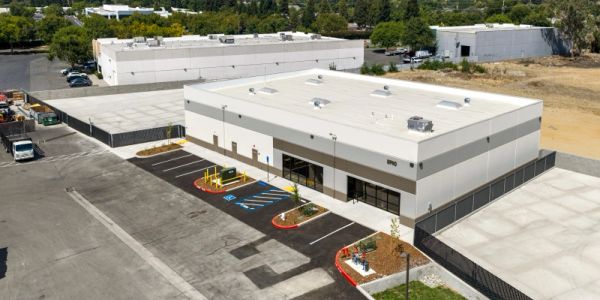 Modern commercial building with ample parking.