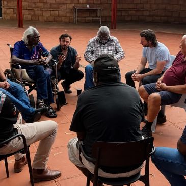 A group of men having a discussion in a circle.