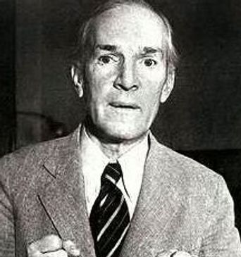 Black and white portrait of a serious elderly man in a suit with clenched fists.