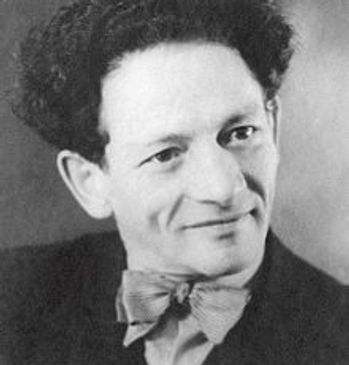 Black and white portrait of a man with curly hair and a bow tie.