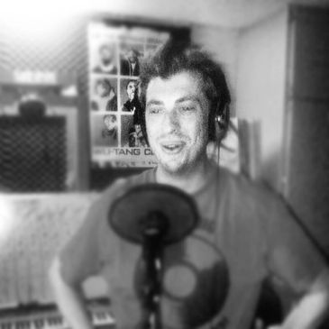 Jeremy behind the microphone adding backup vocals.