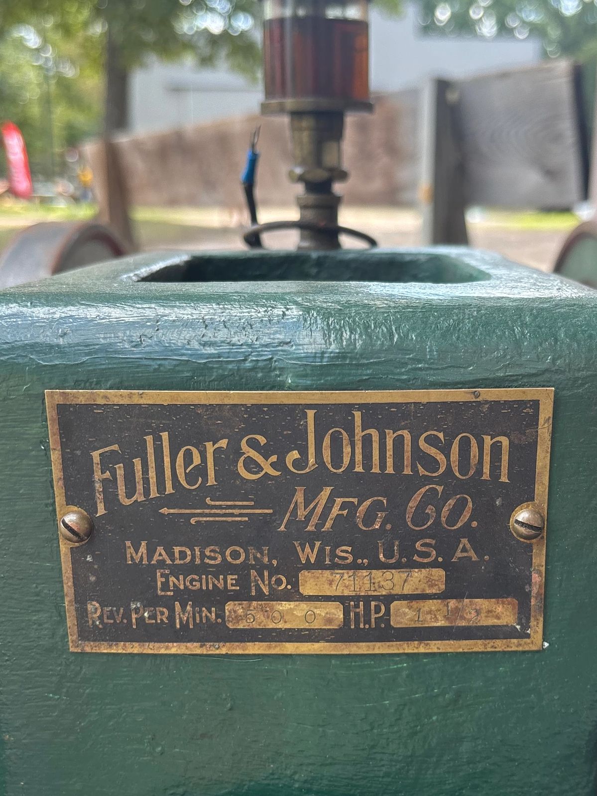 Industrial nameplate on a green machine.