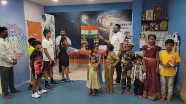 Children and adults gathered indoors, some in costumes.