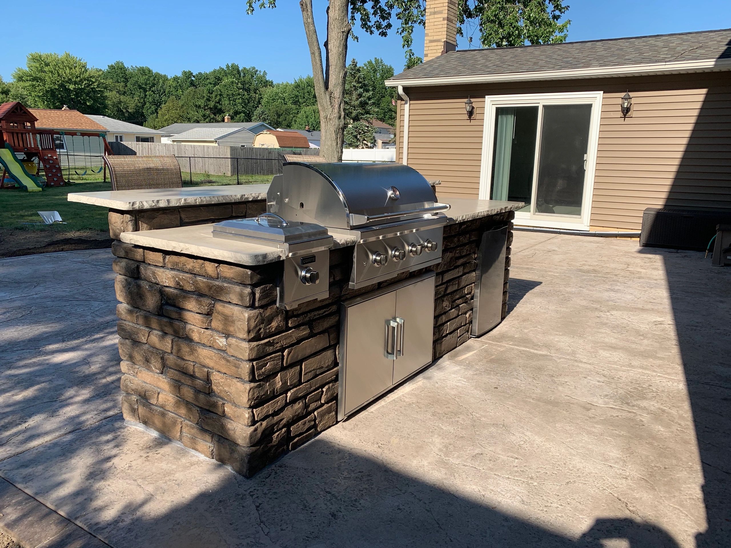 Custom-made 10-foot outdoor kitchen on a stamped concrete patio