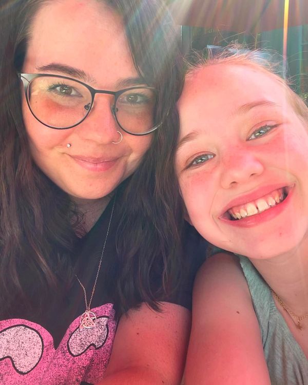 Mother and Daughter smiling in the sun.