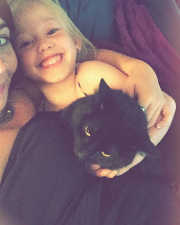 blonde child with mom and black cat