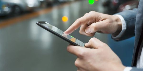 man holding a phone to call a private detective