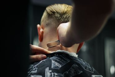 A Man Getting Hair on the Backside Shaved