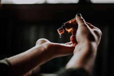 A Woman Dropping Essential Oil on Hands