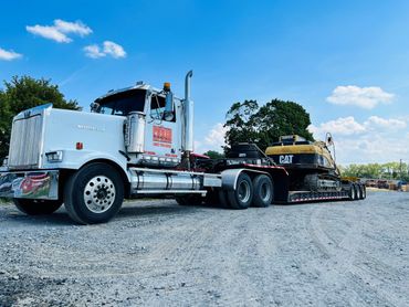 CAT excavator hauling