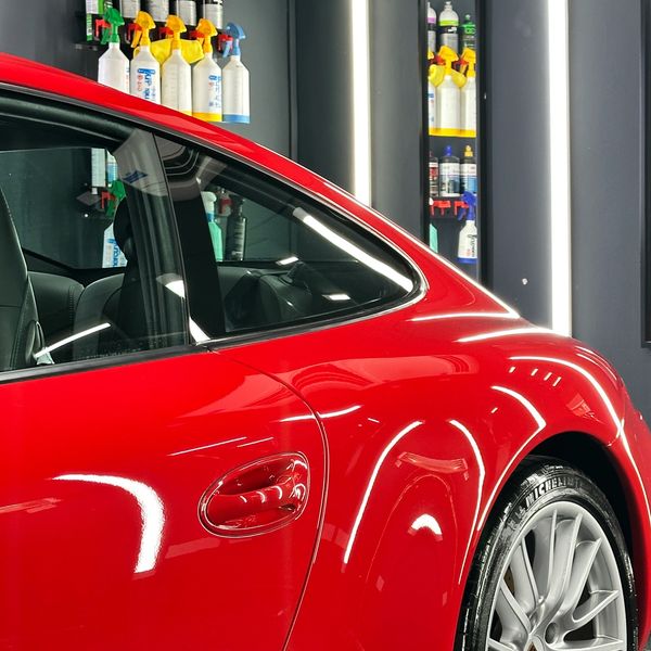 Porsche 911 parked in a detailing bay under lights after a paint correction in wakefield