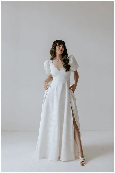 Sadie. V neck wedding dress with puff sleeves, floral fabric and side split with pockets Bracknell
