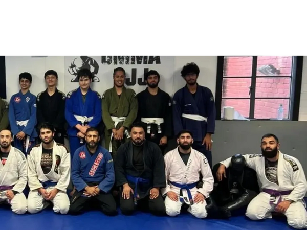 Group photo of UMMA BJJ students smiling after training session