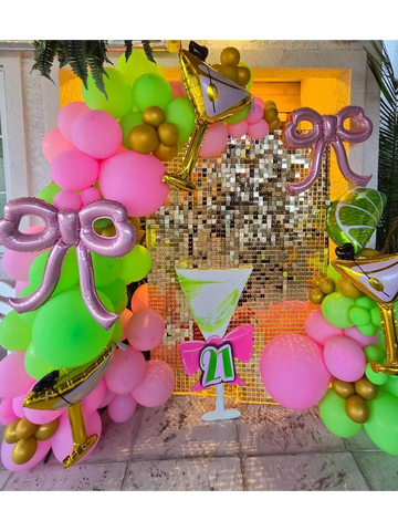Colorful balloon arch with martini glasses and a '21' decoration for a birthday party.