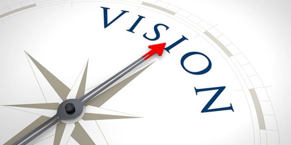 Compass needle pointing to the word 'VISION'.