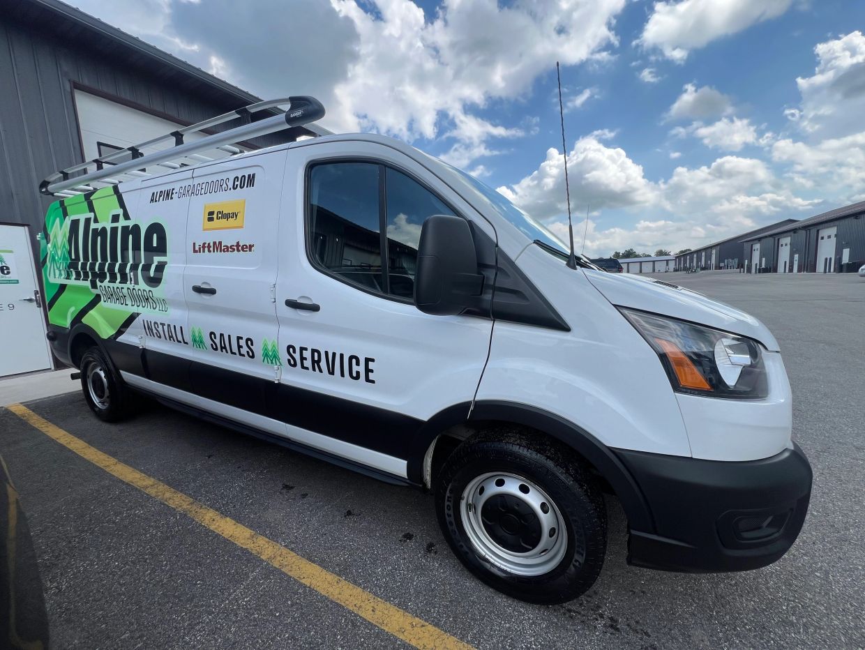 White service van with Alpine Garage Doors branding.
