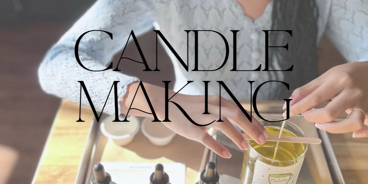 Hands making a candle with wax and wick on a table.