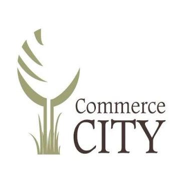 Commerce City logo with stylized tree and grass.