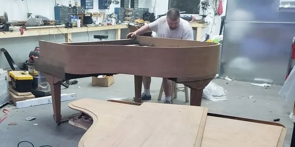 photo of piano being sanded