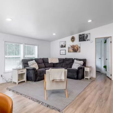 Modern living room with a sectional sofa and armchair.