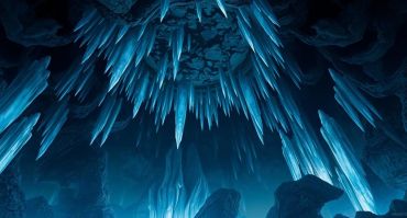 Cave full of blue crystals hanging from the cave ceiling.