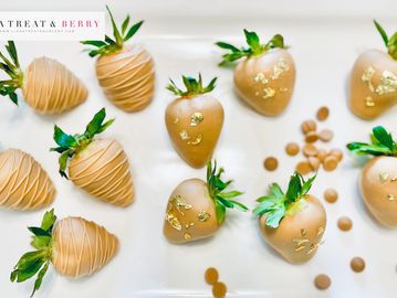 luxury chocolate covered strawberries dipped in gold couverture chocolate with gold leaf garnish 