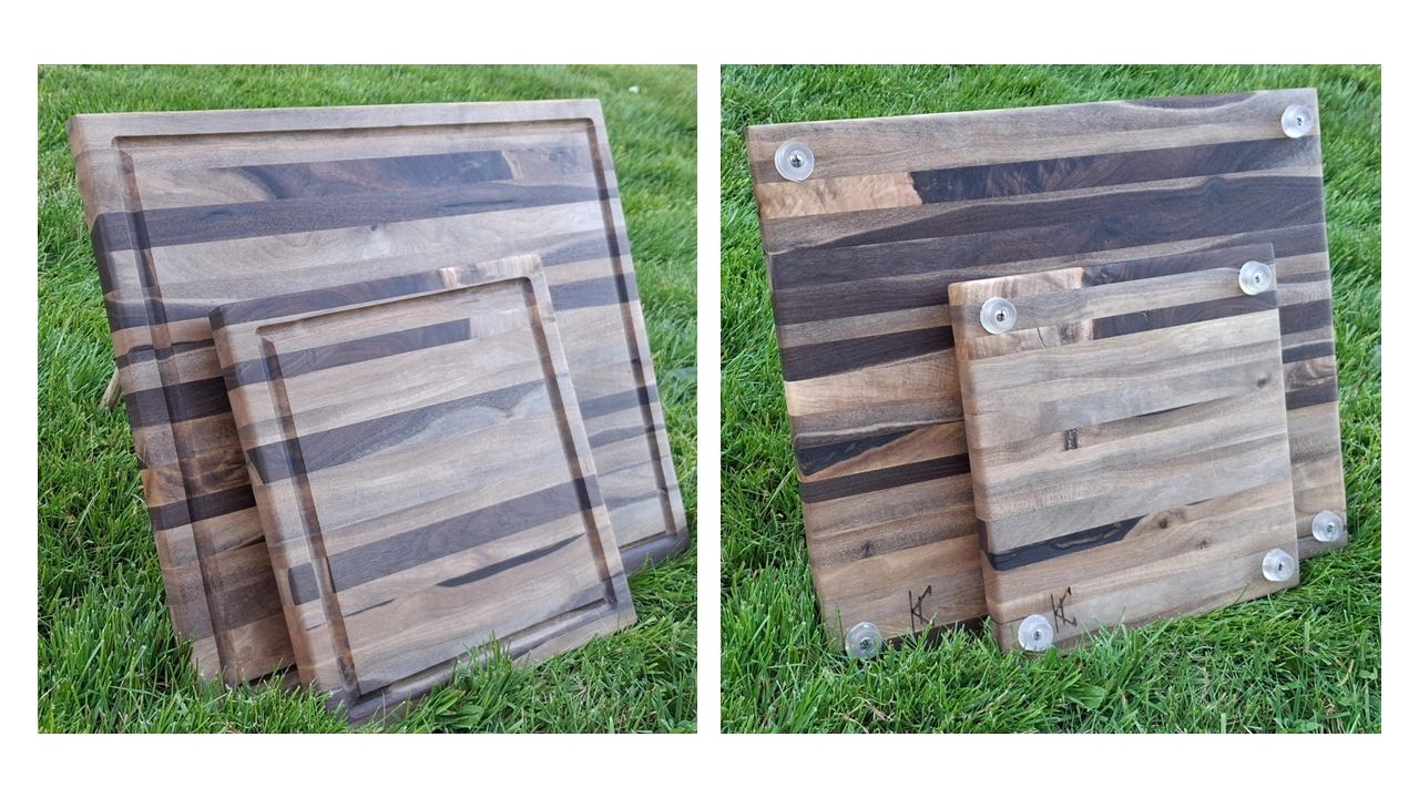 Two wooden cutting boards with grooves and rubber feet, placed on grass.
