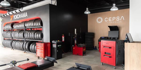 Modern tire shop with Yokohama tires and CEPSA branding.