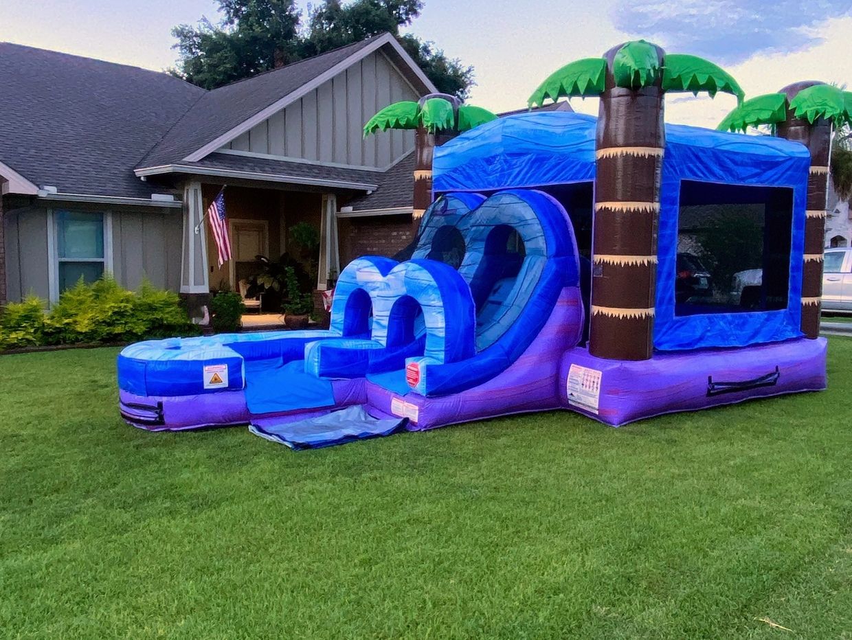 Smaller kid's tropical themed inflatable bounce house with water slide combo unit