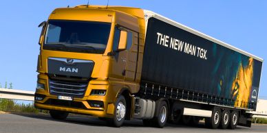 Yellow MAN TGX truck on the road