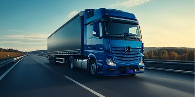 A blue Mercedes truck on a highway.