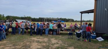 Guests gather around outdoor crawfish tables at the 2024 Doyle Boil.