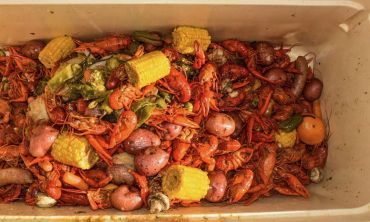 Boiled crawfish, shrimp, corn, potatoes, and vegetables ready to eat at the 2025 Doyle Boil.