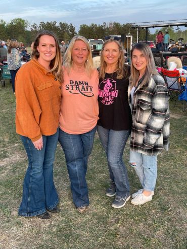 Four guests smile together with the stage behind them at the 2023 Doyle Boil.